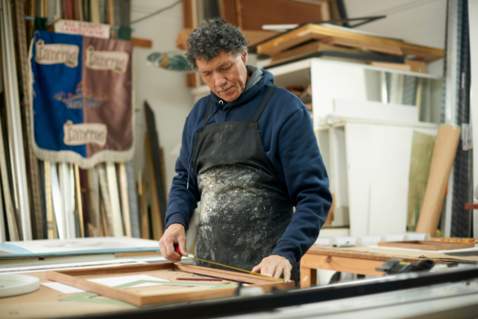 Woodwork, repair and man measuring a frame for pictures, furniture or maintenance in a workshop. Creative, design and handyman with wood for a canvas, production and construction business in a studio